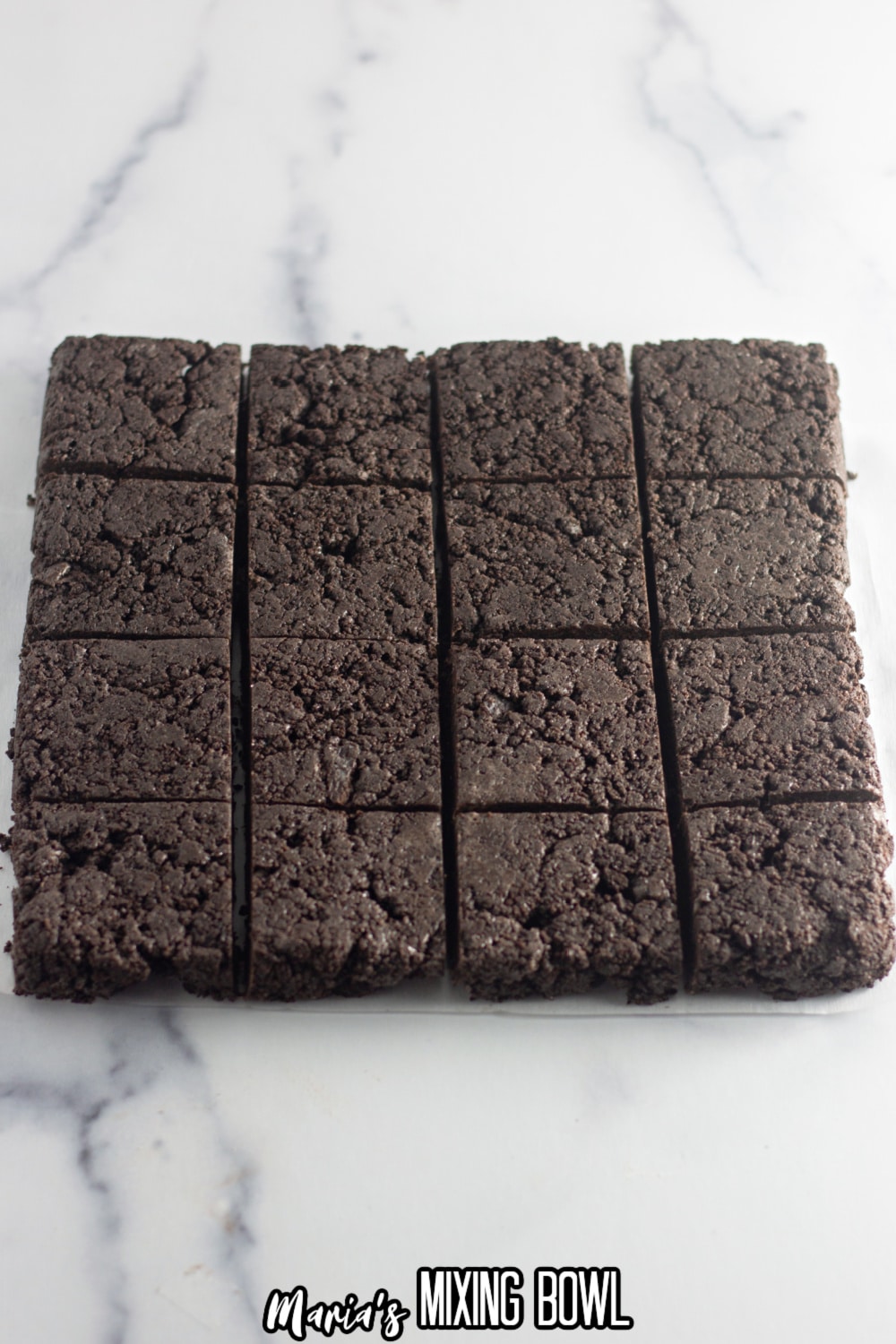 12 oreo bars just being cut into squares on a marble backdrop