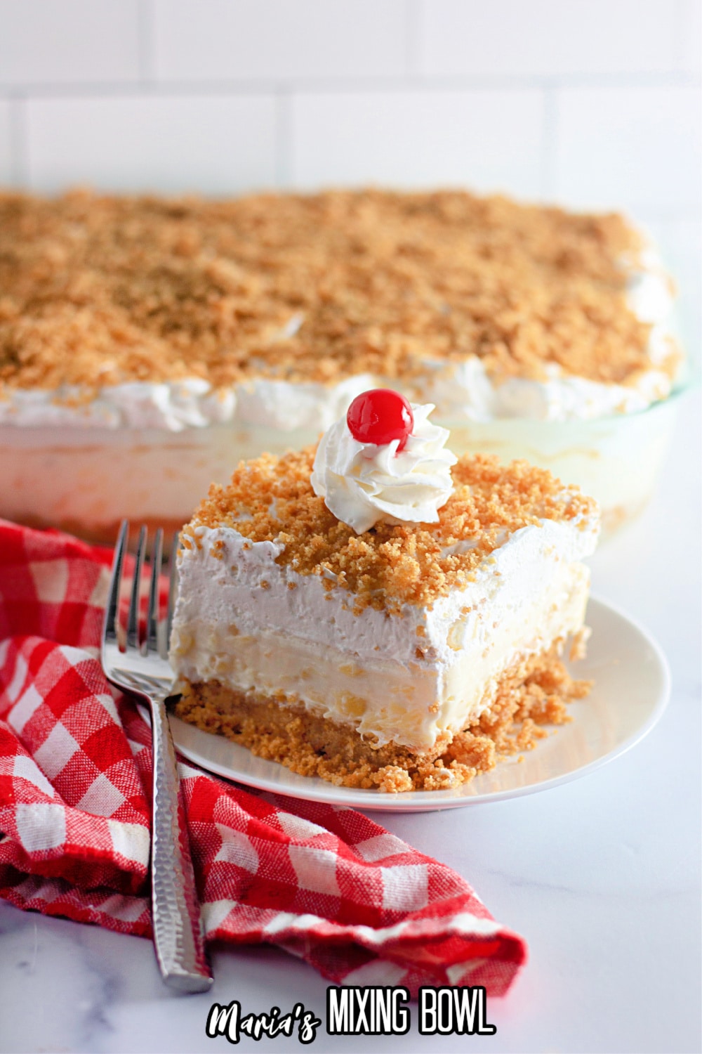 slice of pineapple lush on a white plate with a sliver fork