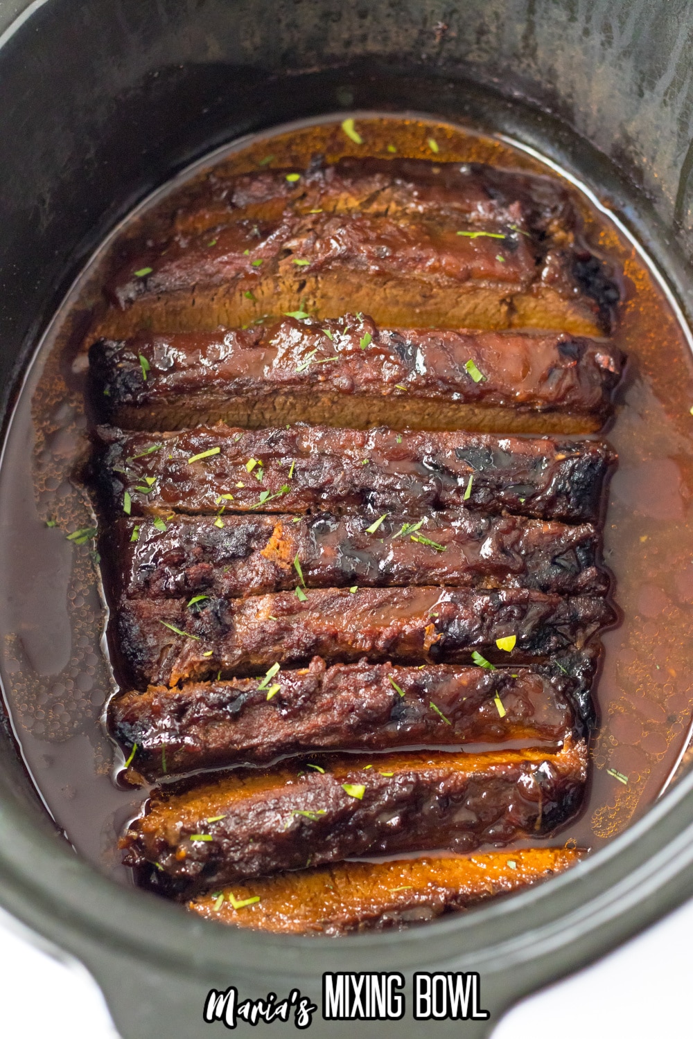 sliced brisket in a slow cooker
