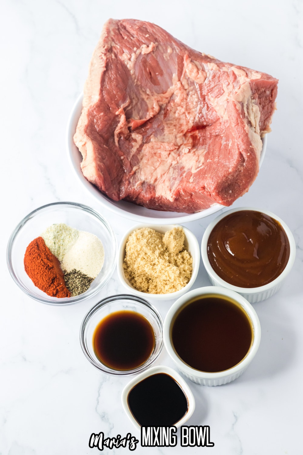 bowls of raw beef brisket, brown sugar, bbq sauce, beef broth, Worcestershire sauce, onion powder, garlic salt, black pepper and paprika on a white background