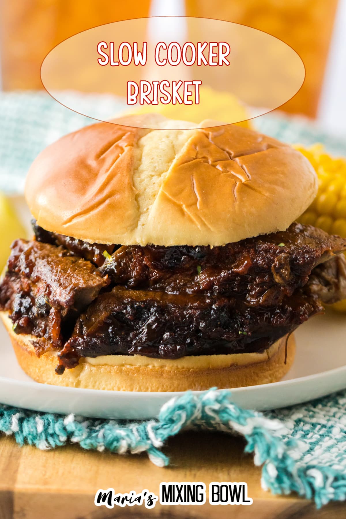 close up of sliced beef brisket sandwich on an off white plate