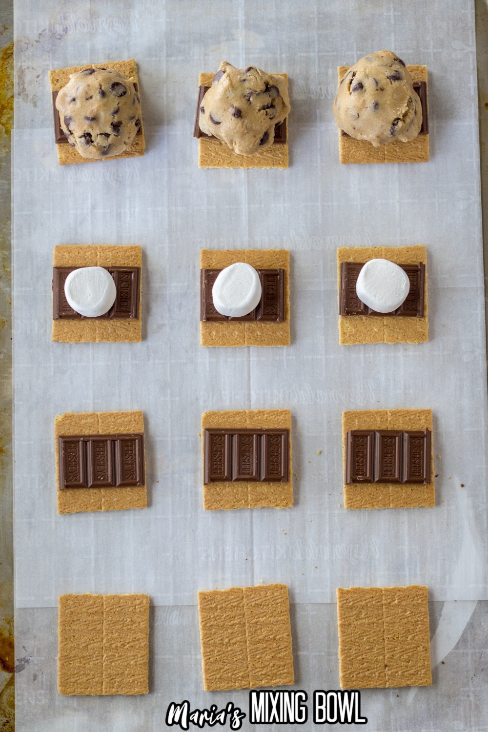 cookie dough being pressed on top graham crackers