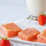slices strawberry cake mix brownies on a white platter