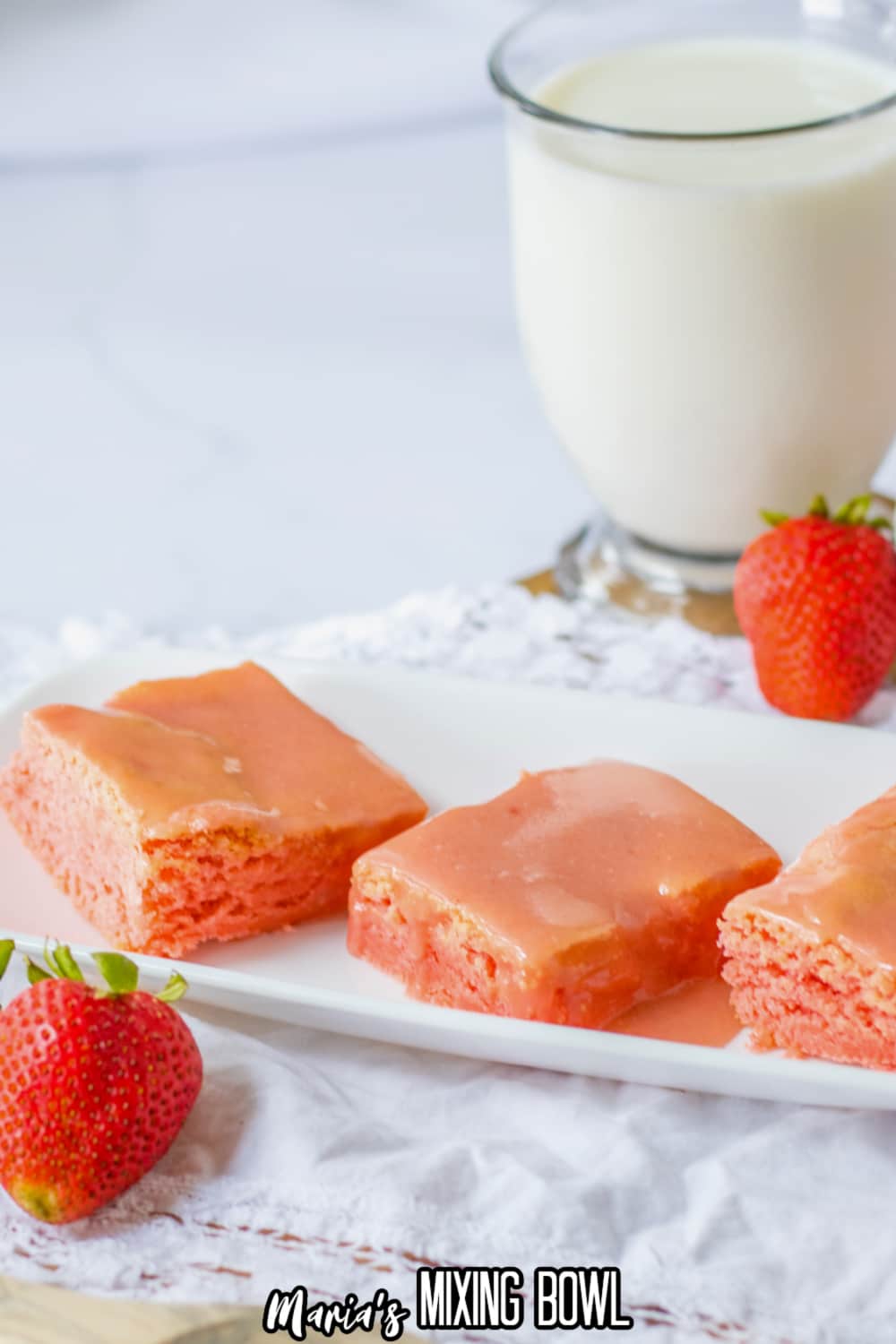 slices strawberry cake mix brownies on a white platter