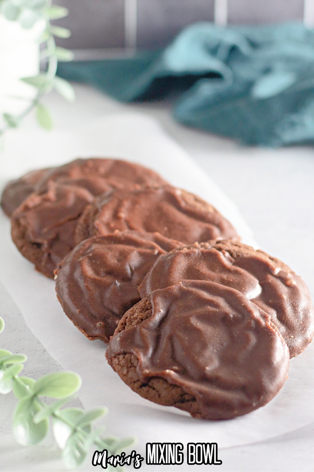 7 texas sheet cake cookies on a piece of parchment paper on a white background