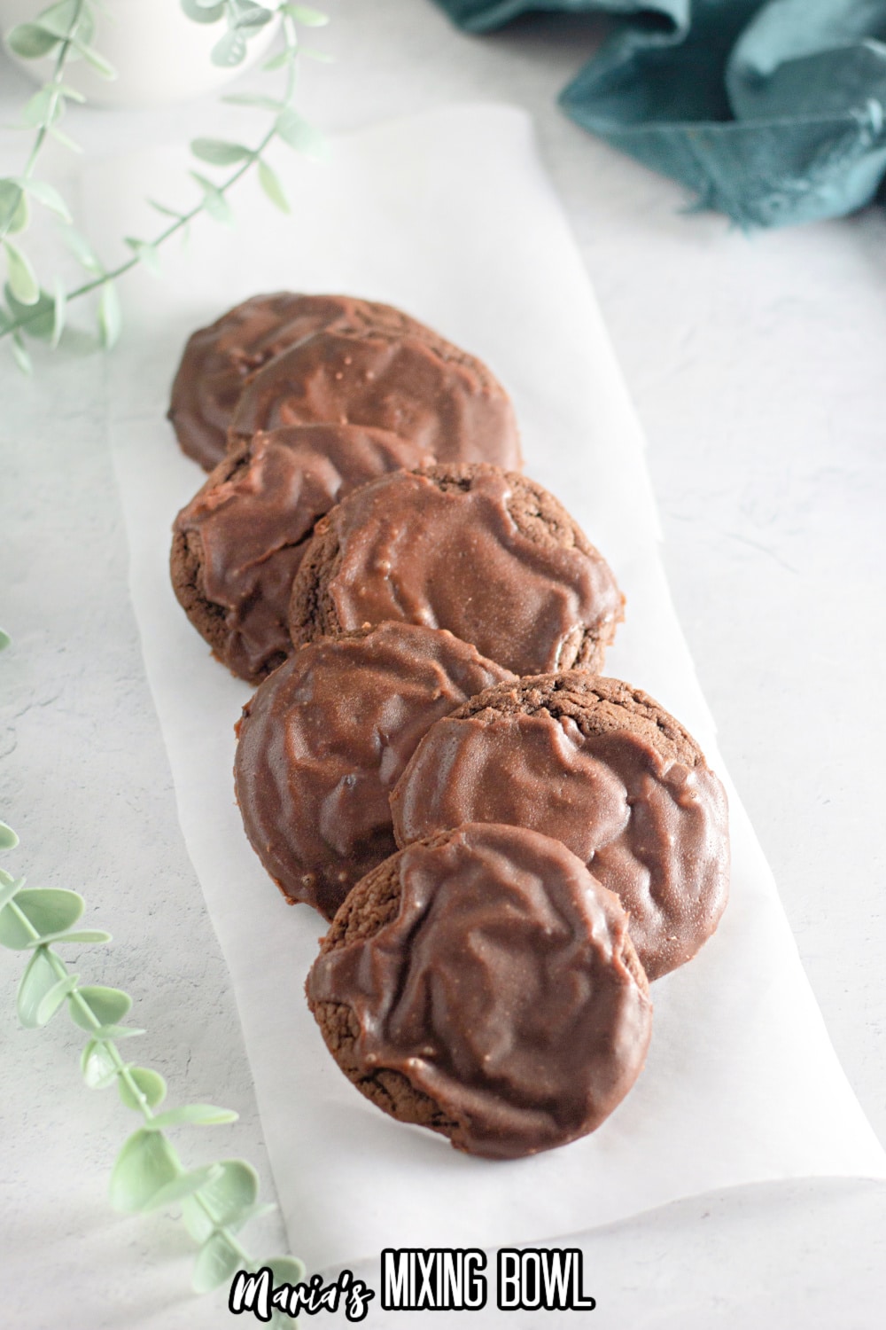 7 texas sheet cake cookies on a piece of parchment paper on a white background