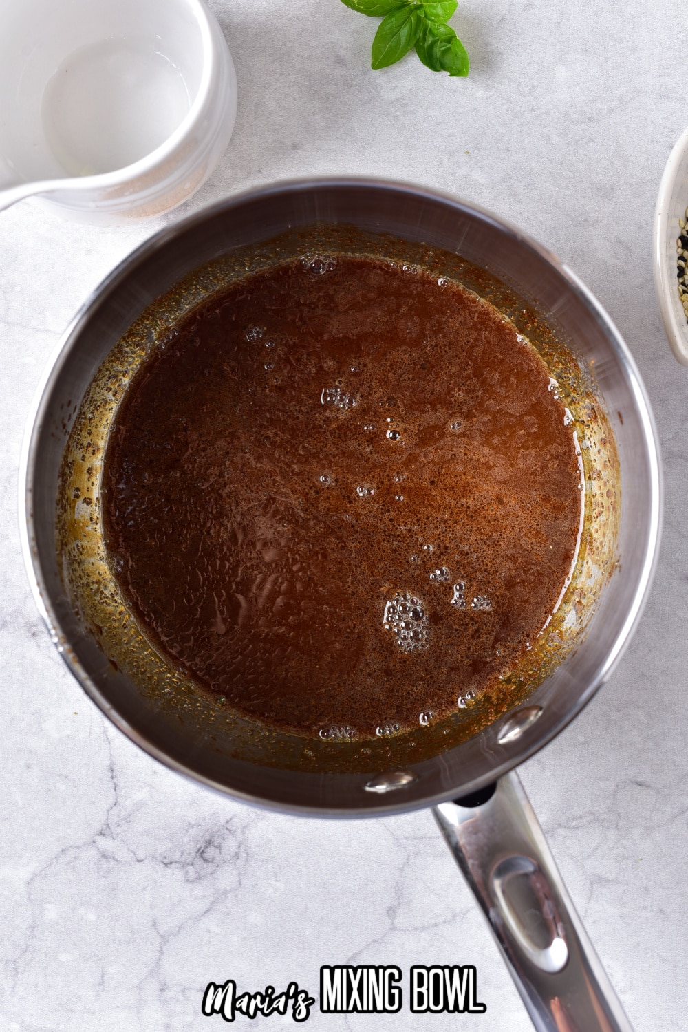 homemade teriyaki sauce bubbling in a stainless steel saucepan.