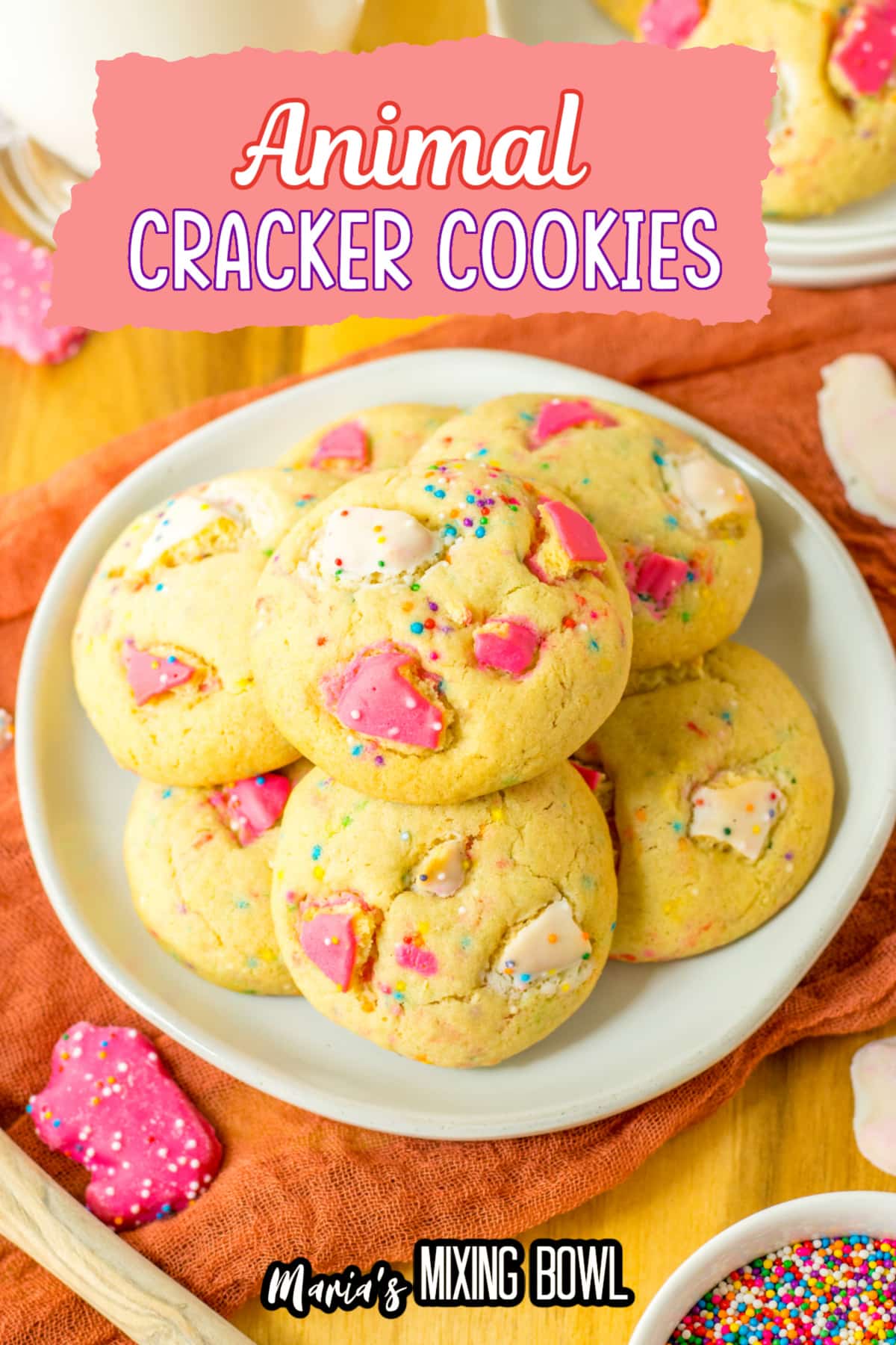 seven animal cracker cookies stacked on a plate.