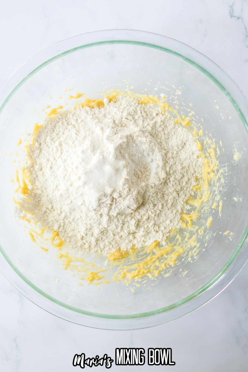 flour, salt, and baking powdered added to a bowl filled with wet ingredients.