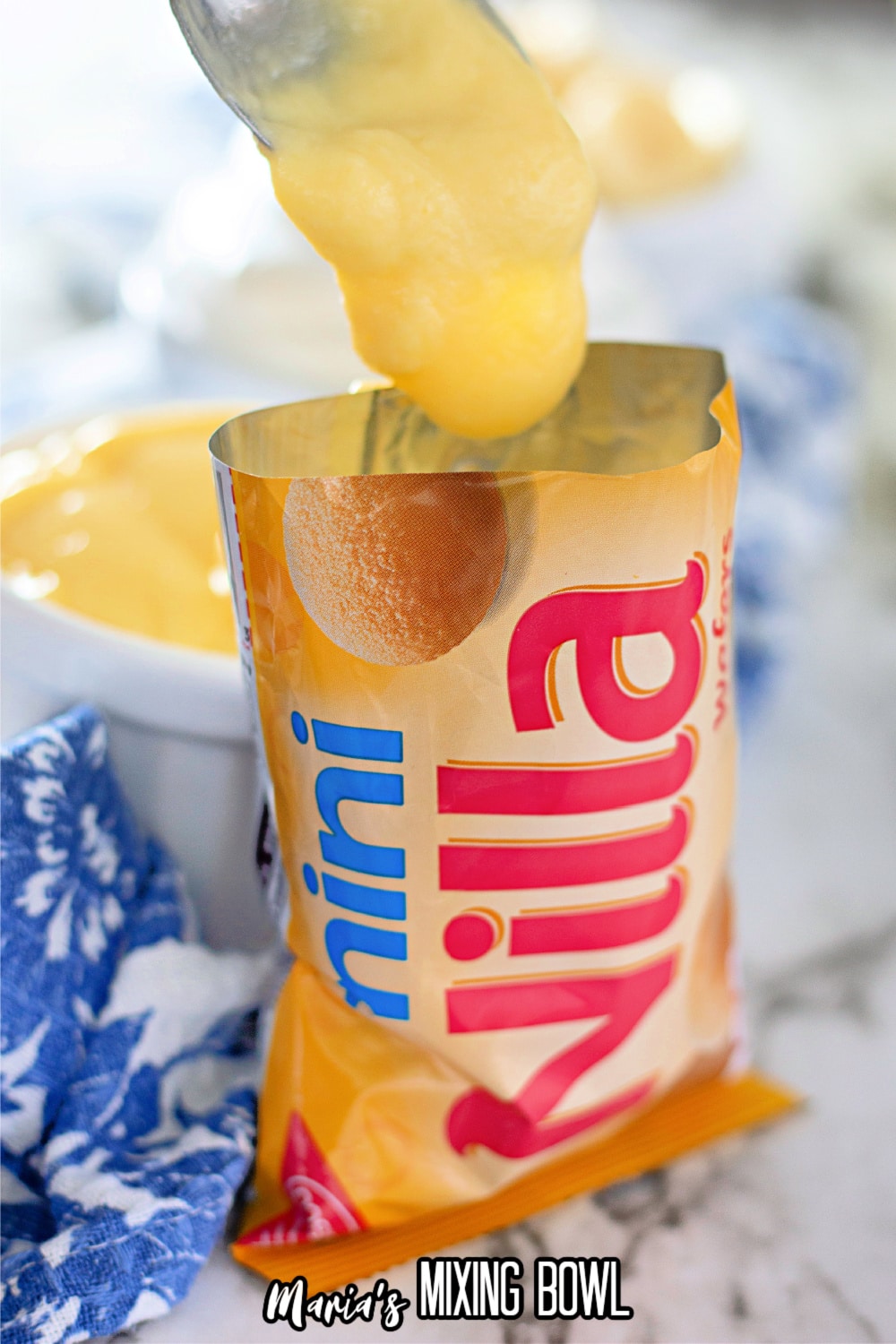 vanilla pudding being added to a mini vanilla wafer bag