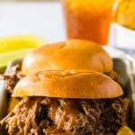 bbq beef sandwich on a metal serving tray.