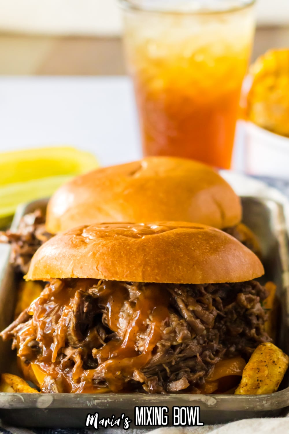 bbq beef sandwich on a metal serving tray.