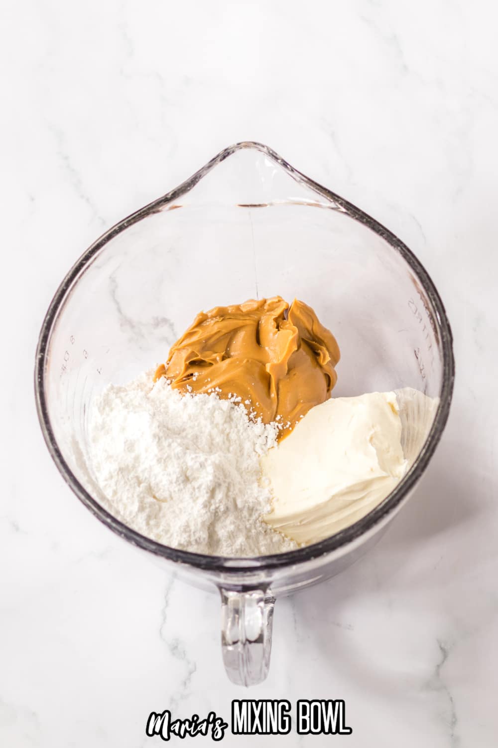 peanut butter, powdered sugar, and cream cheese in a glass measuring cup