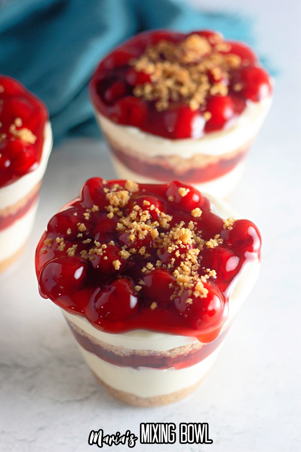 three cheesecake cups on a white marble background
