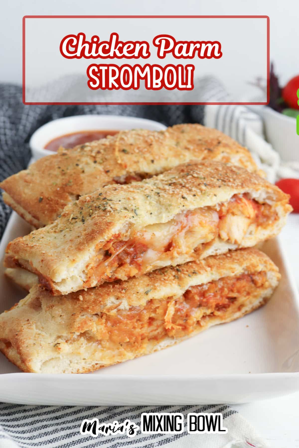 slices of stromboli on a white rectangular platter with a jar of pasta sauce