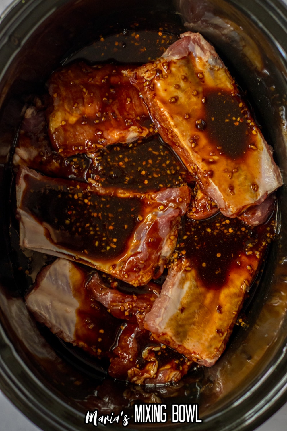 raw ribs and chinese inspired sauce in the slow cooker