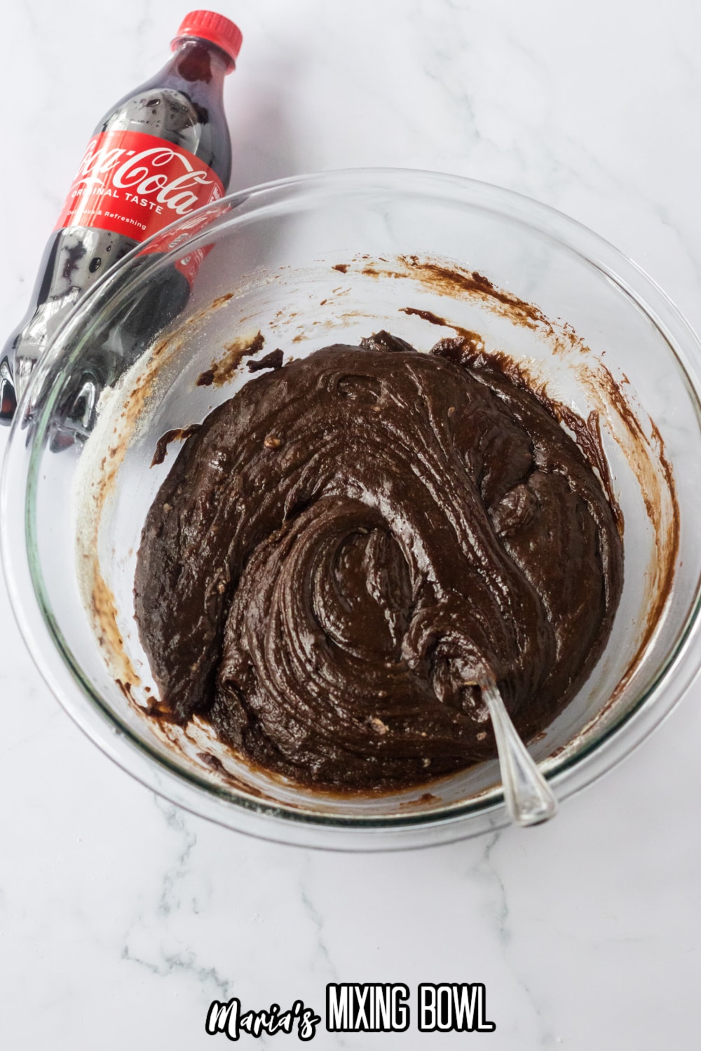 chocolate cake batter in a large glass mixing bowl