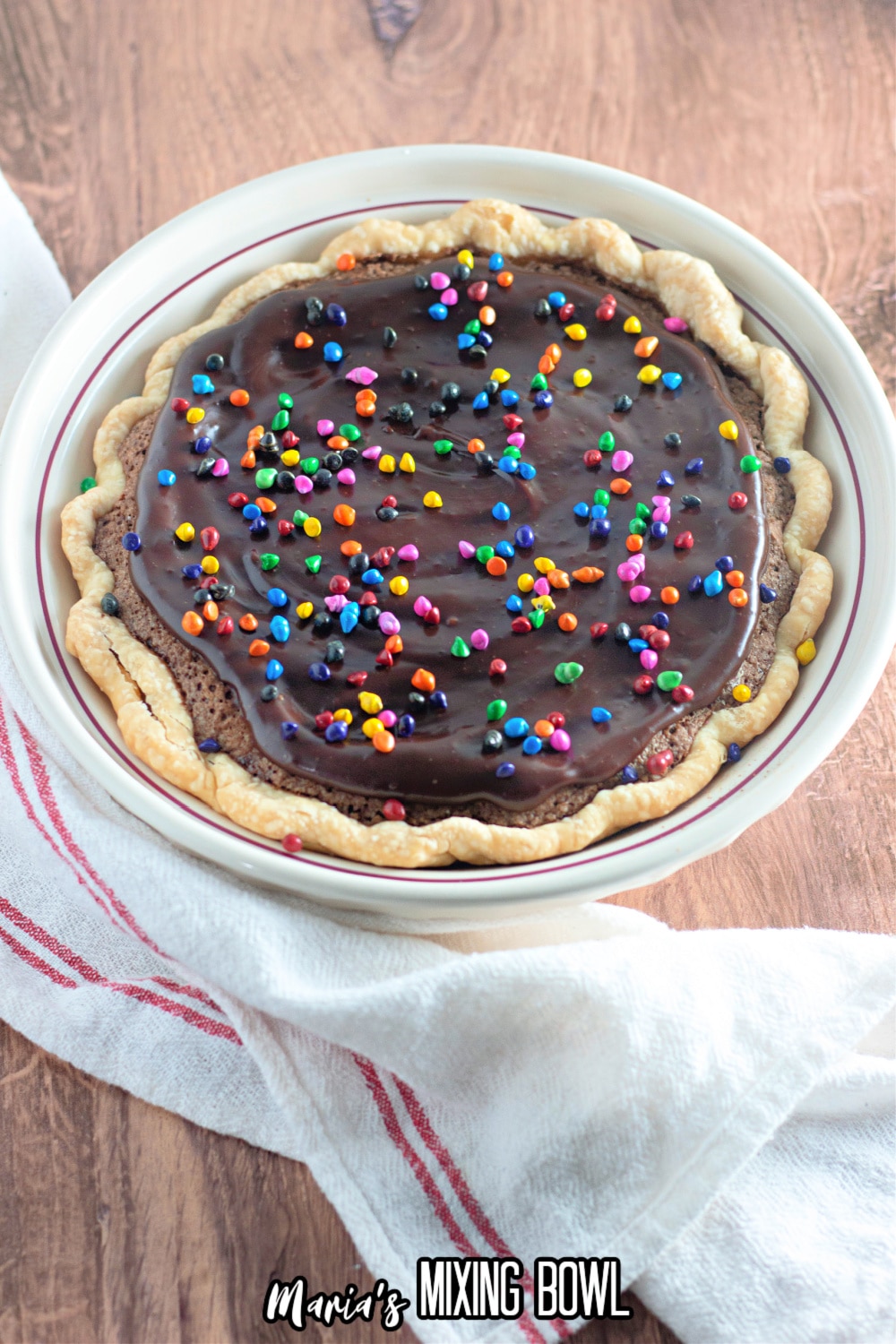 uncut brownie pie topped with rainbow sprinkles