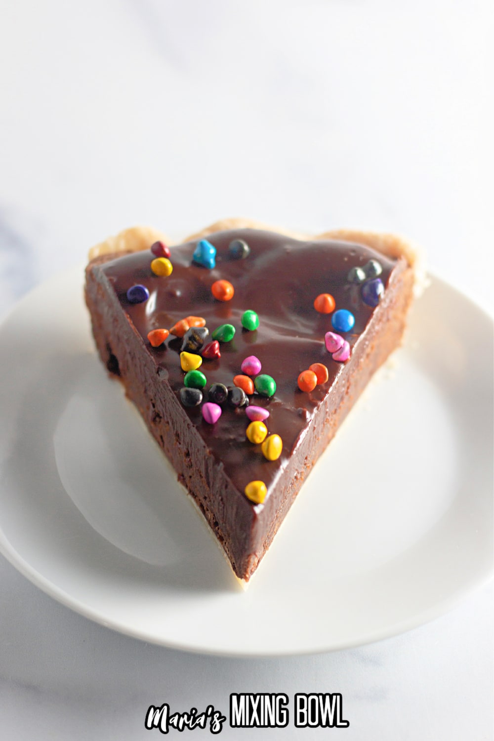 slice of cosmic brownie pie on a white plate