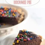 slice of cosmic brownie pie on a white plate with cosmic brownie pie written in text