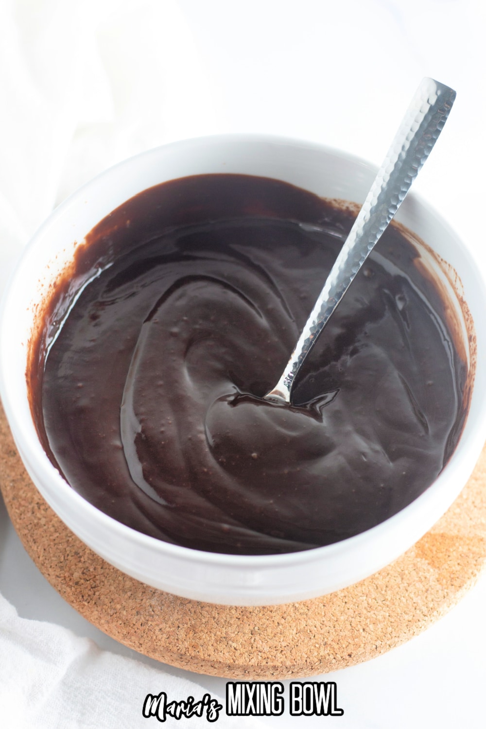 chocolate ganache being mixed in a small white bowl
