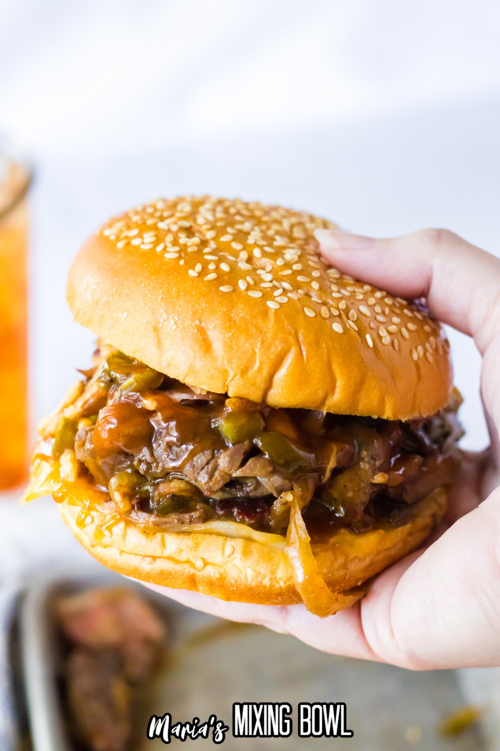 cowboy sandwich held in a woman's hand in the air