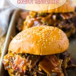 two slow cooker cowboy sandwiches on a metal tray