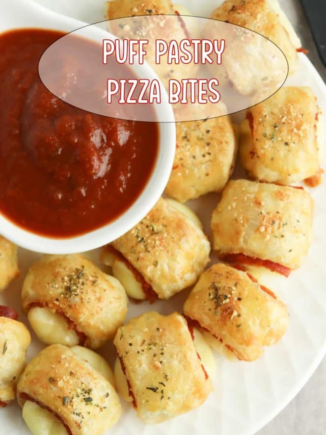 puff pastry pizza bites on a white plate with a bowl of marinara sauce