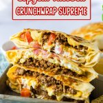 crunchwrap cut in half and stacked on top of each other on a metal tray.