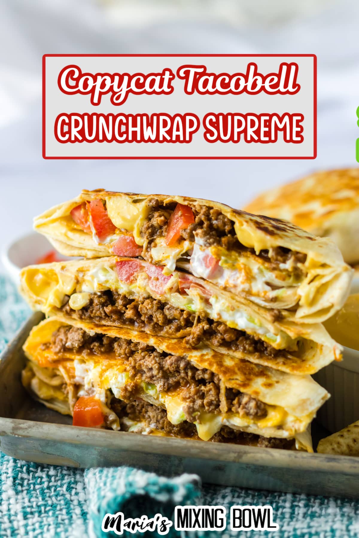 crunchwrap cut in half and stacked on top of each other on a metal tray.