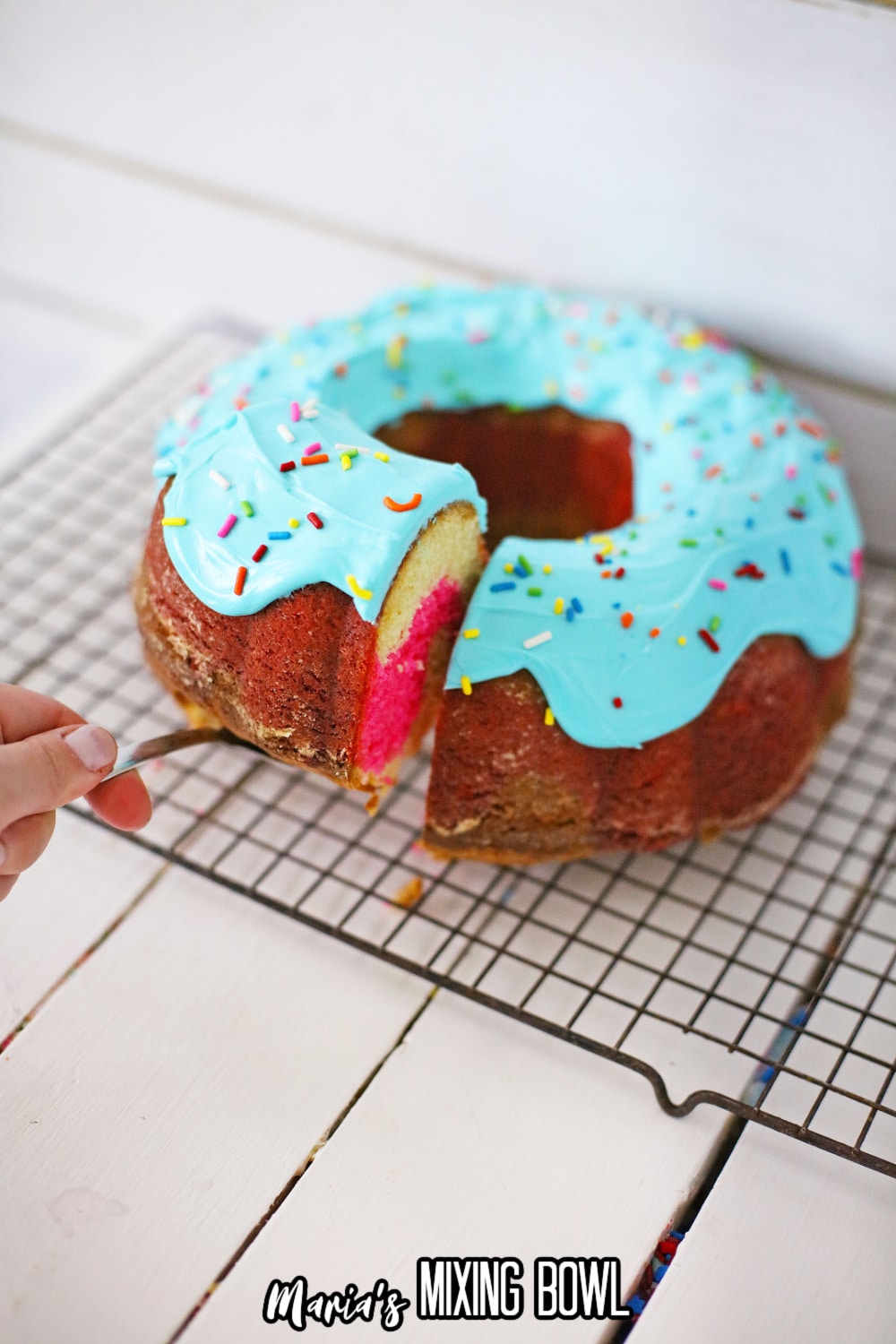 slice of donut cake being removed from the cooling rack