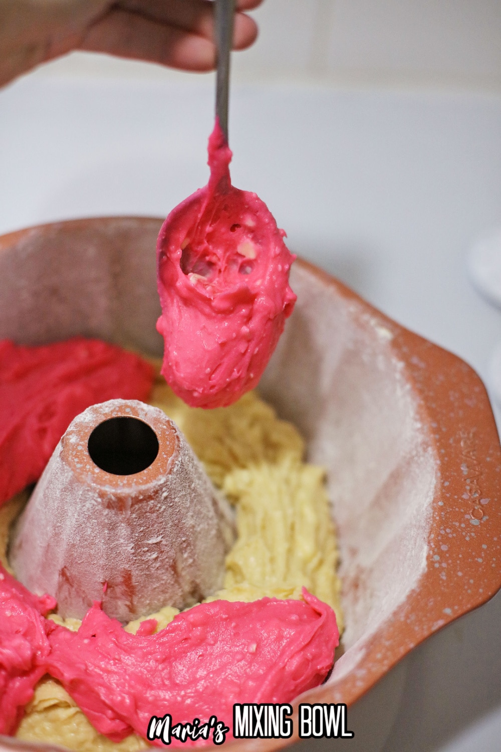 pink and white cake better being layered in a bundt cake pan