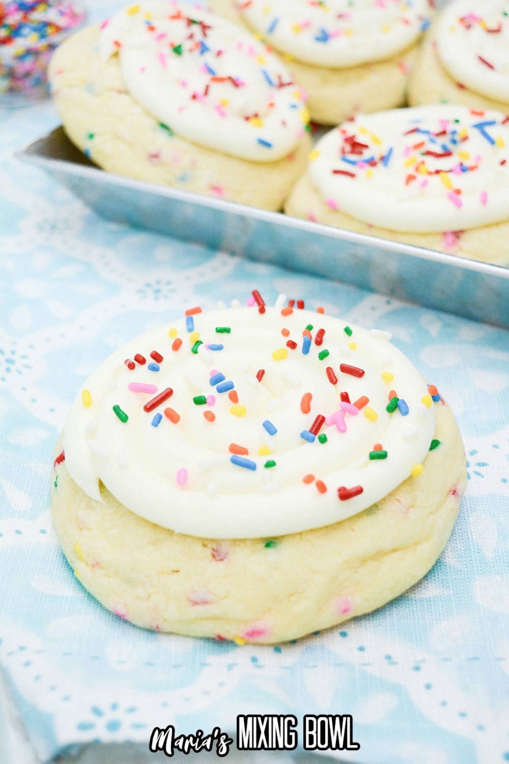 frosted sugar cookies on a blue and white napkin