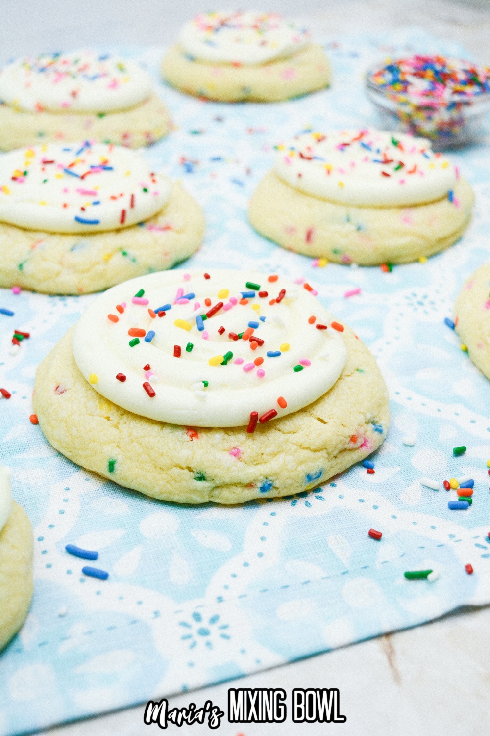 finished birthday cake cookies on a blue and white napkin