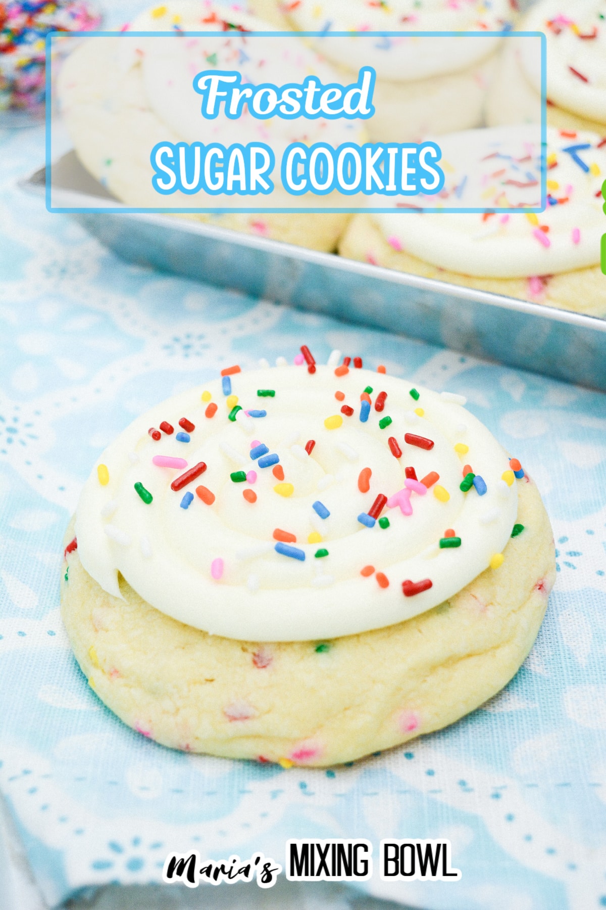 frosted sugar cookies on a blue and white napkin