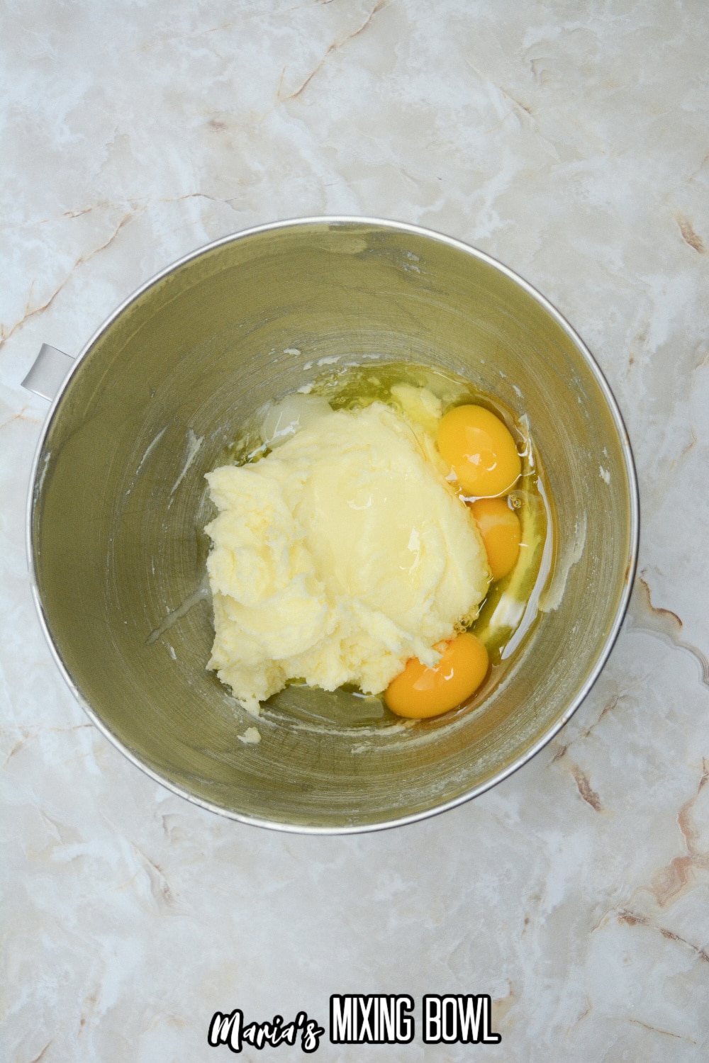 eggs, butter and sugar in a stainless steel mixing bowl