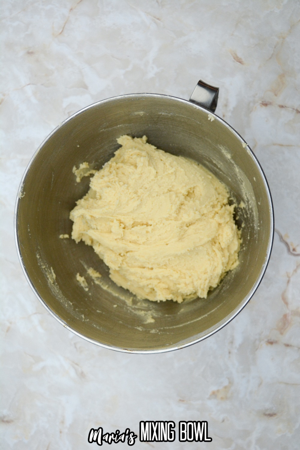 cookie dough in a stainless steel mixing bowl
