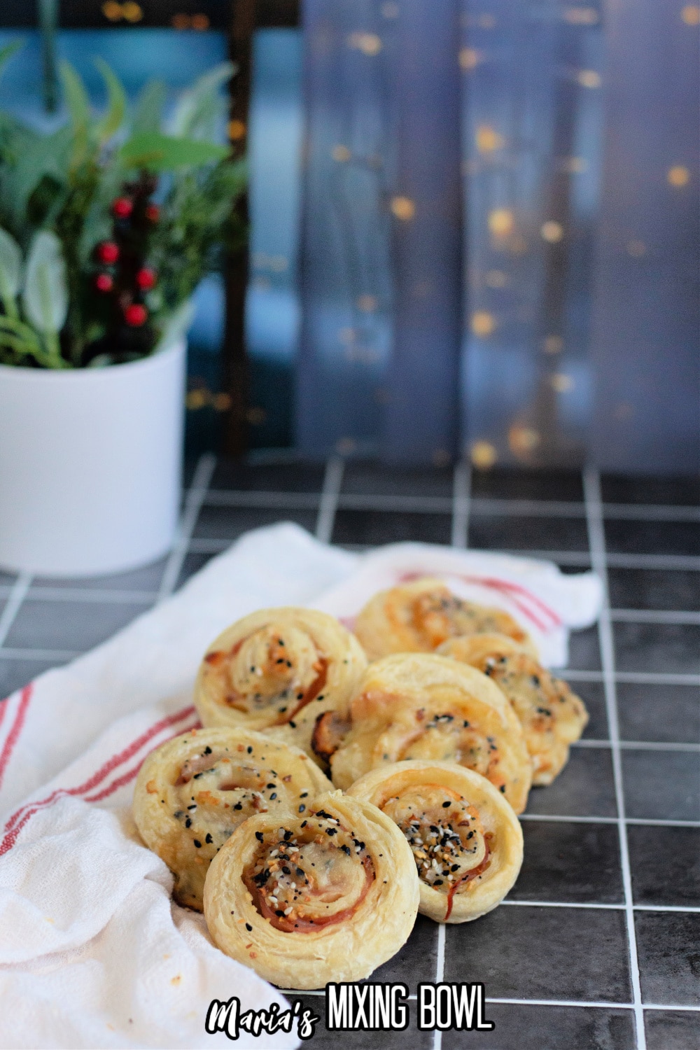 slices of ham and cheese pinwheels on a cooling spray on a dark background
