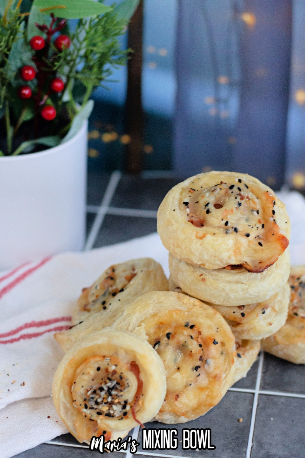 slices of ham and cheese pinwheels on a cooling spray on a dark background