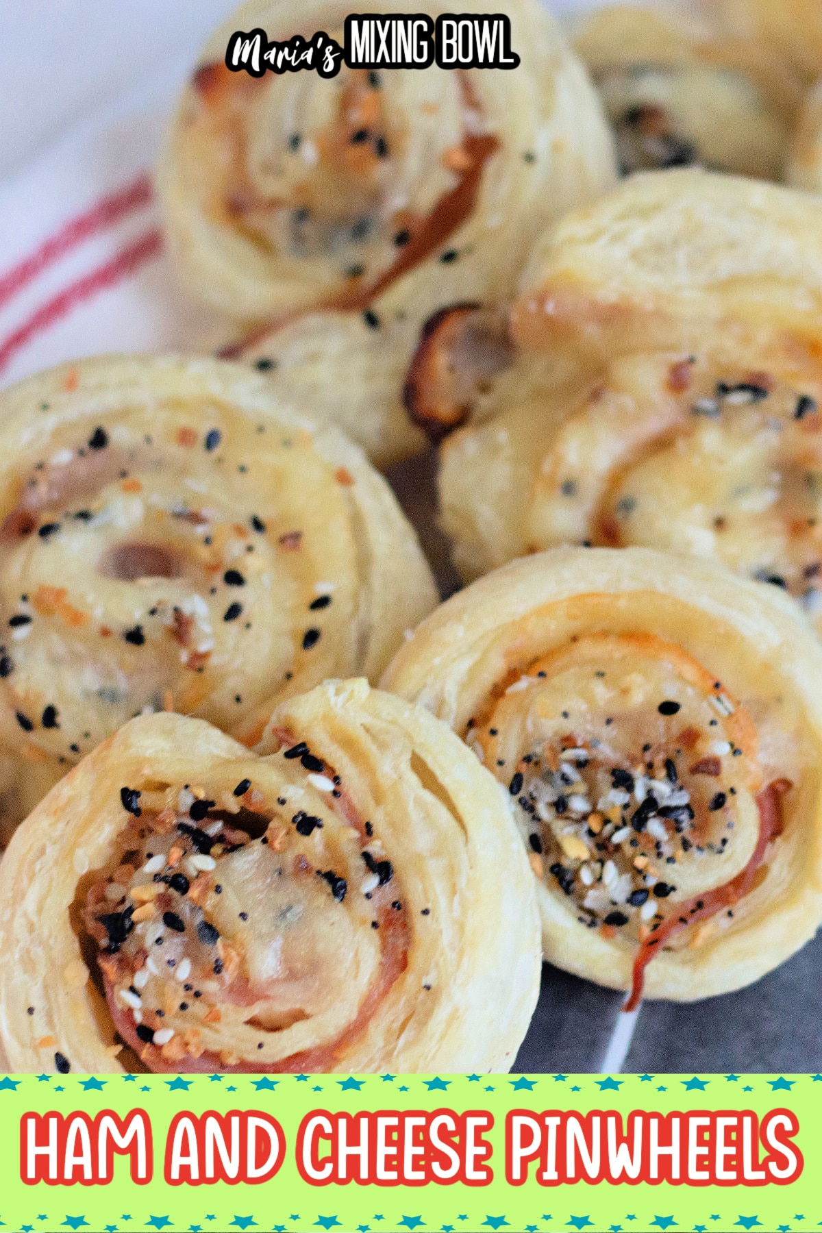 slices of ham and cheese pinwheels on a cooling spray on a dark background