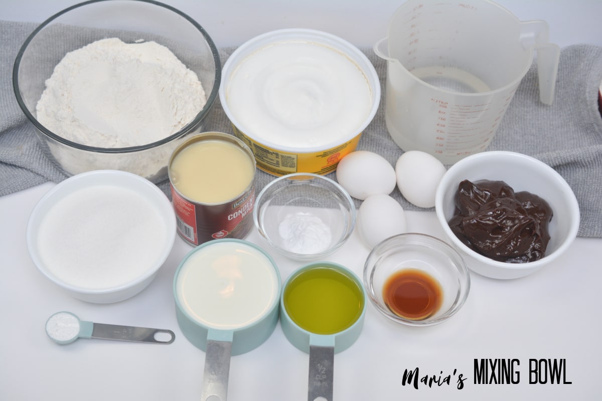 bowls of flour, sugar, baking powder, baking soda, salt, oil, eggs, vanilla extract.