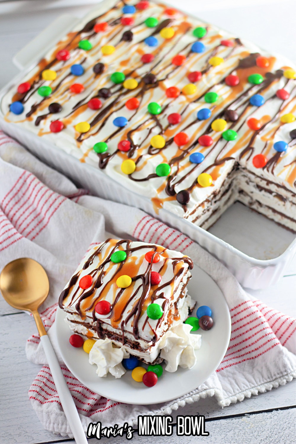 slice of ice cream sandwich cake on a white plate with the entire cake behind it