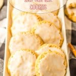 12 iced oatmeal cookies lined in two rows on a white rectangular platter.