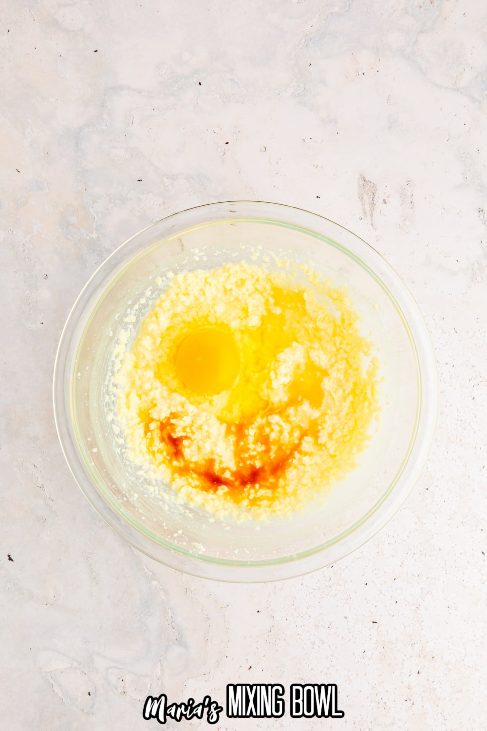 butter, sugar, eggs and vanilla in a glass mixing bowl