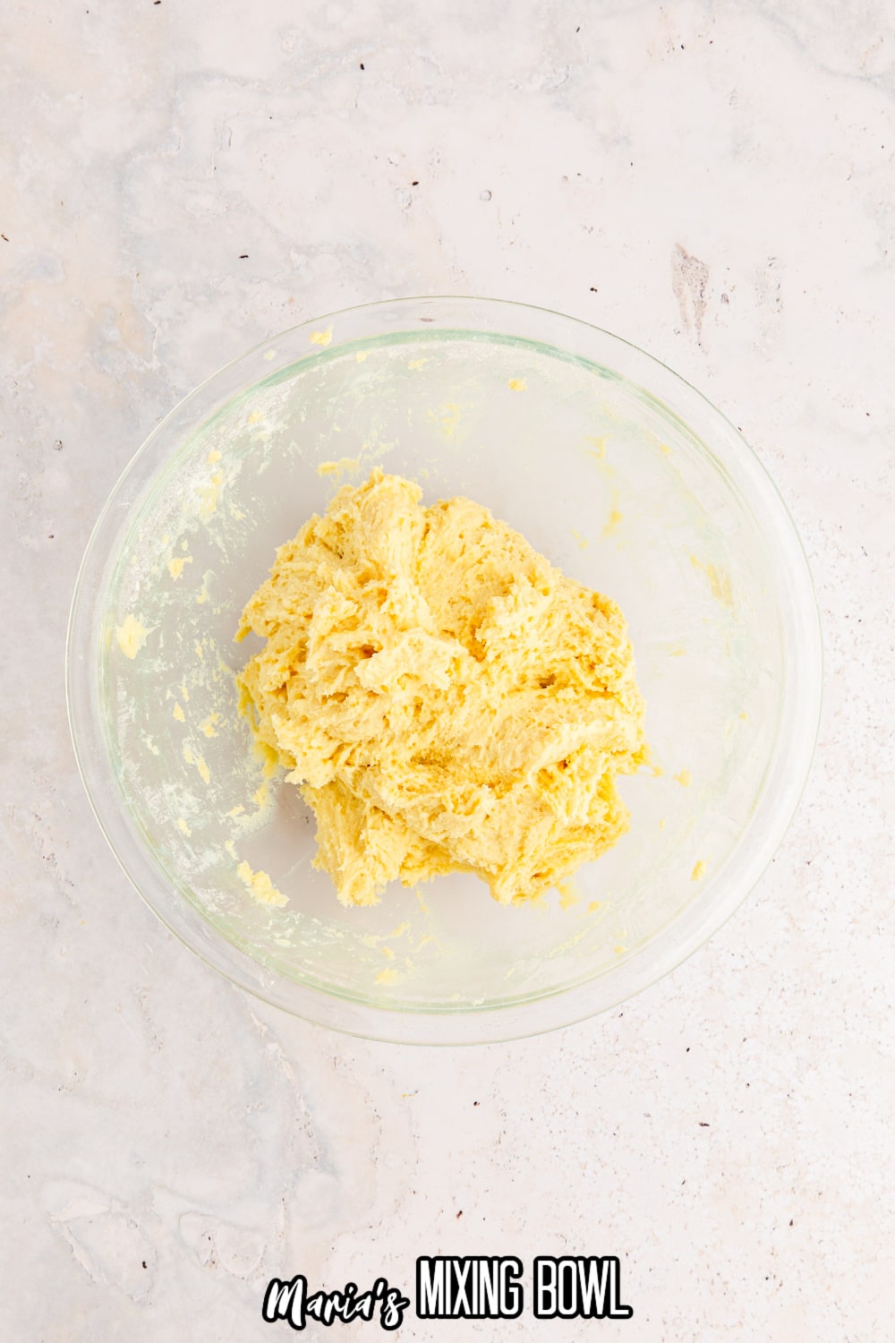 cookie dough in a glass mixing bowl