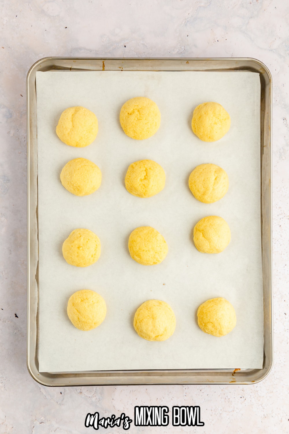 baked cookies on a parchment lined baking sheet with rimmed edges