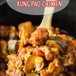 large wooden spoonful of kung pao chicken held above a slow cooker