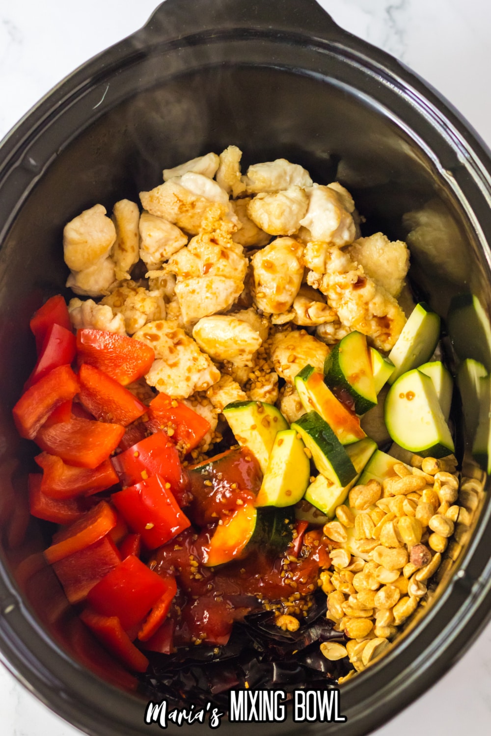 cooked chicken, bell pepper, sliced zucchini, and corn in a slow cooker