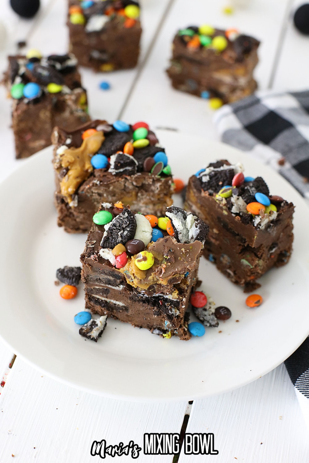 three pieces of loaded peanut butter cup fudge on a plate