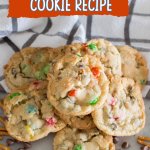 loaded pretzel cookies on a marble counter with pretzels and chocolate chips around it